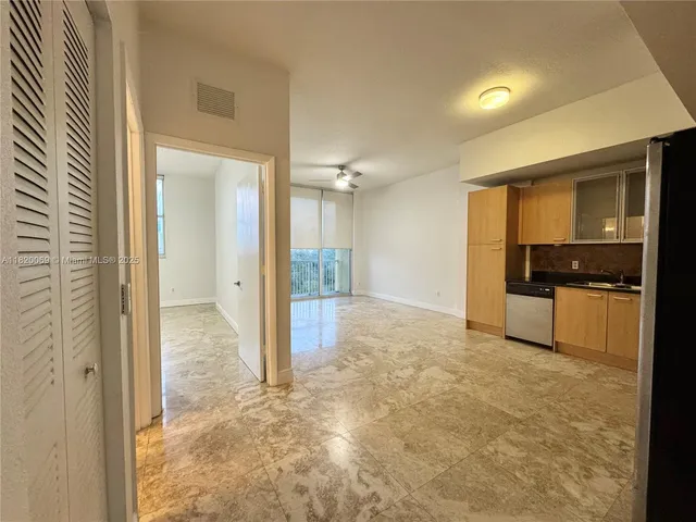 a view of a kitchen with a sink and cabinets