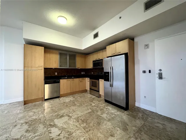 a kitchen with stainless steel appliances a refrigerator and a stove