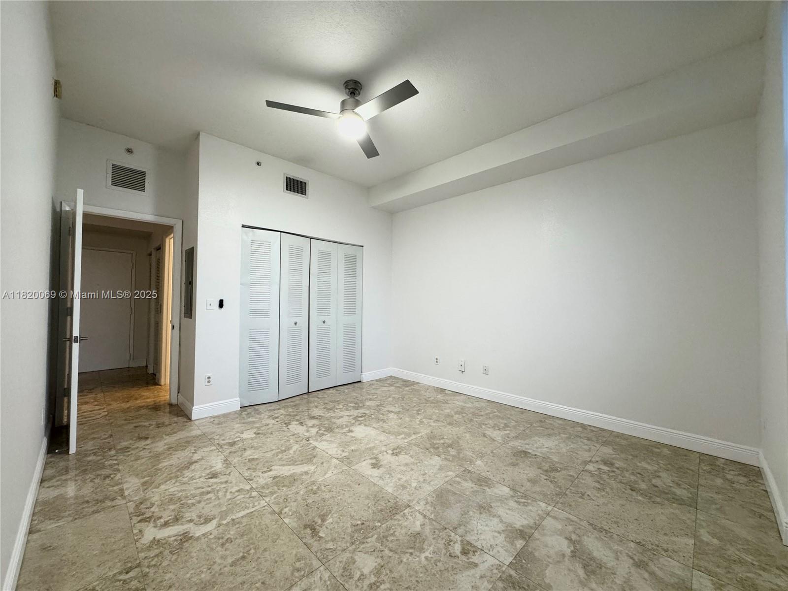 1350 Northwest 8th Court, Unit B35 Miami, FL 33136 - Photo 10 of 22 an empty room with closet and a ceiling fan