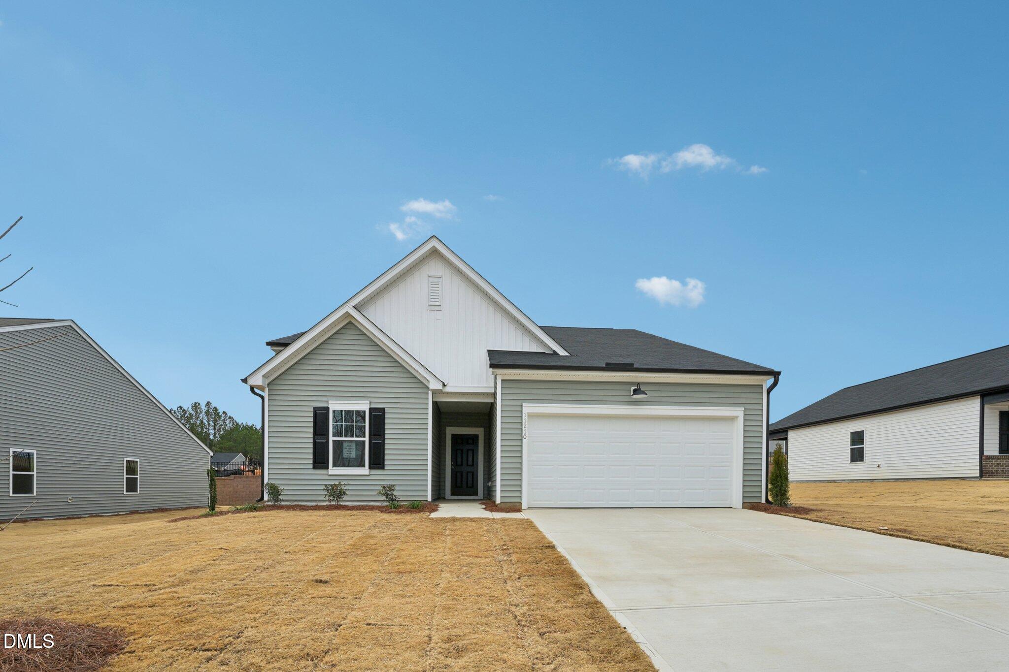 a view of house with yard and garage