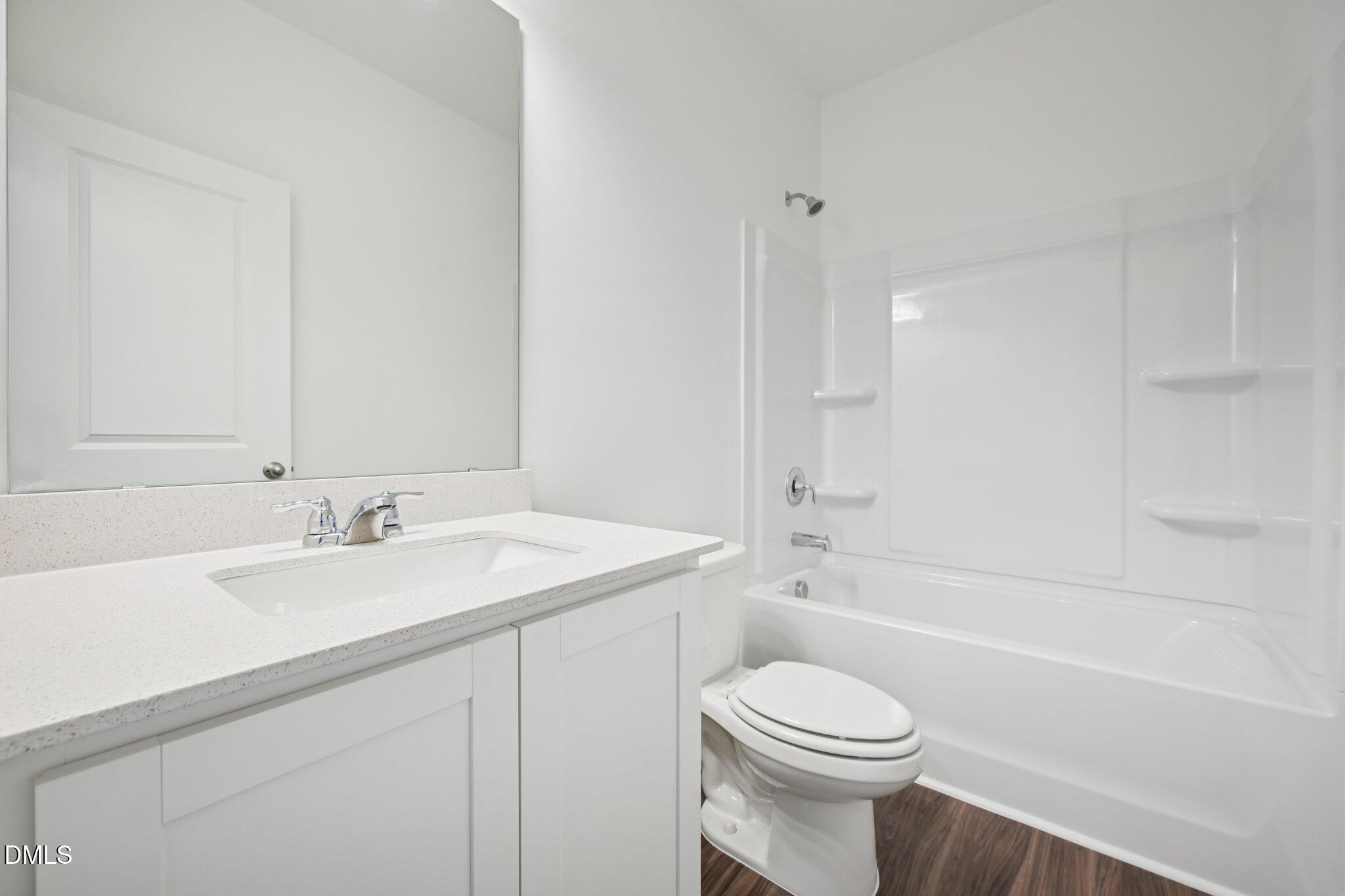 11210 Salers Loop Middlesex, NC 27557 - Photo 13 of 53 a bathroom with a sink a toilet and a bathtub