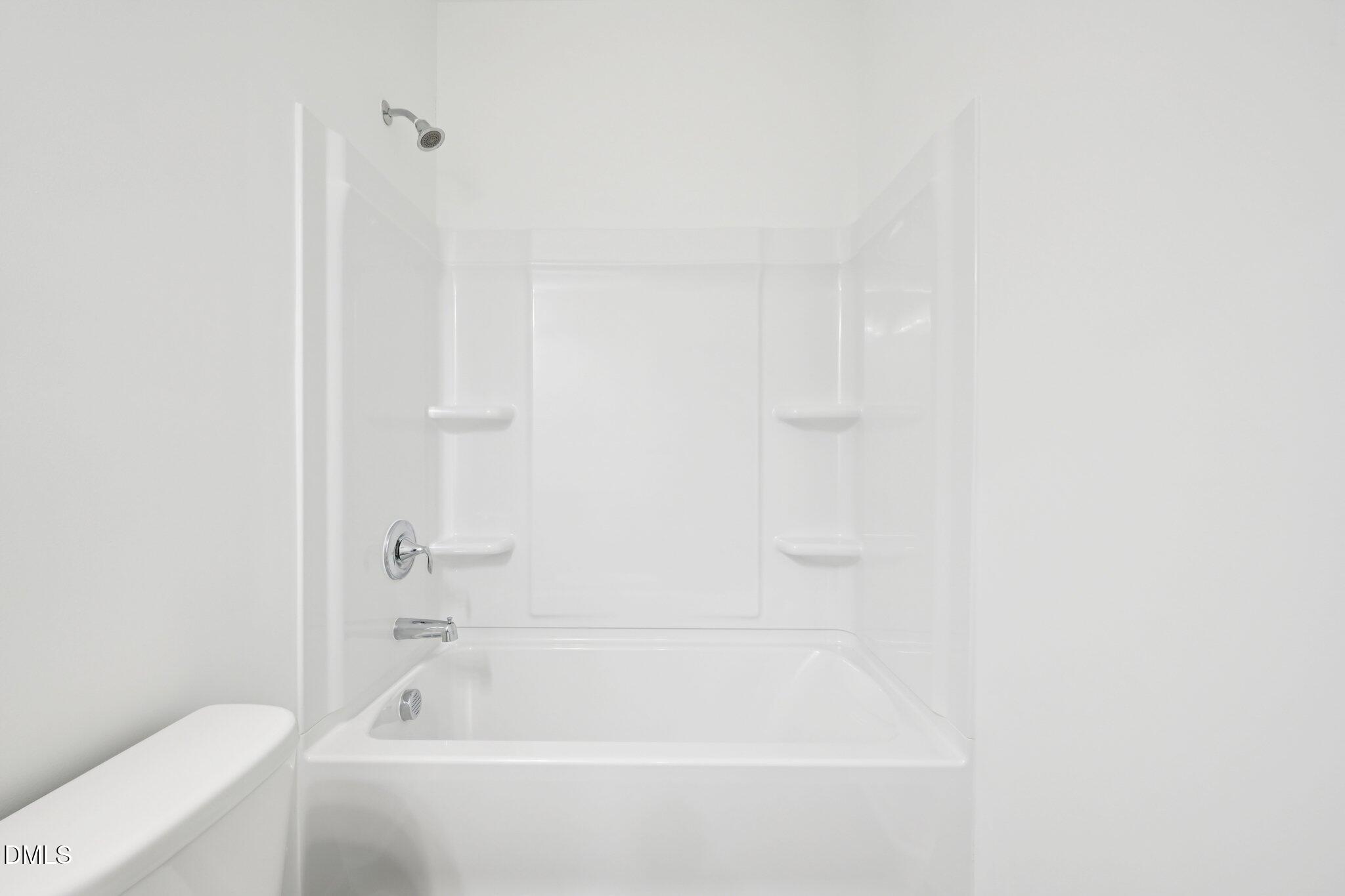 11210 Salers Loop Middlesex, NC 27557 - Photo 14 of 53 a bathroom with a bathtub and a toilet