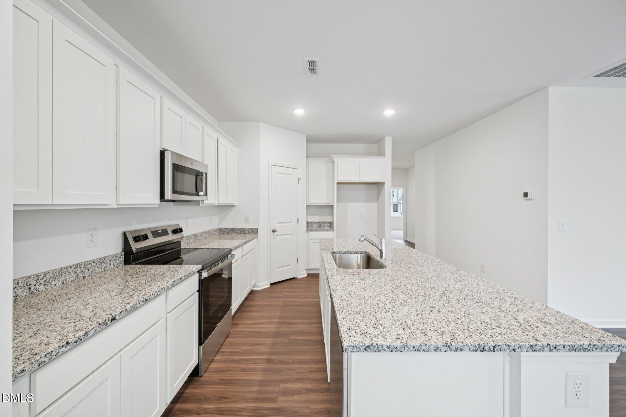 11210 Salers Loop Middlesex, NC 27557 - Photo 19 of 53 a kitchen with stainless steel appliances granite countertop a sink stove and refrigerator