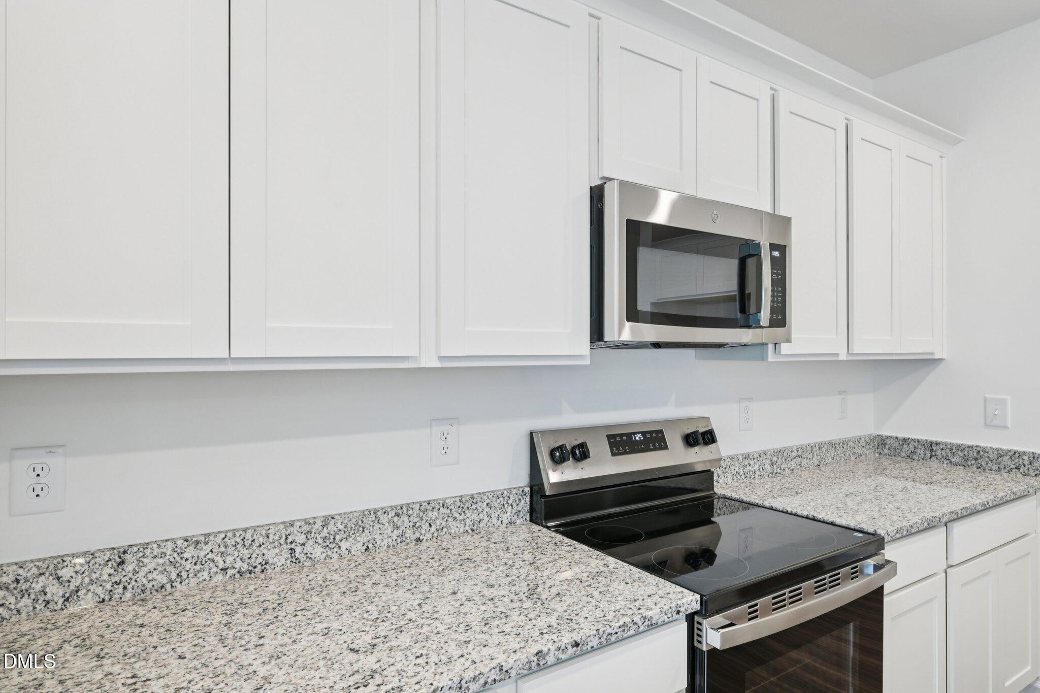 11210 Salers Loop Middlesex, NC 27557 - Photo 20 of 53 a kitchen with a stove and a microwave
