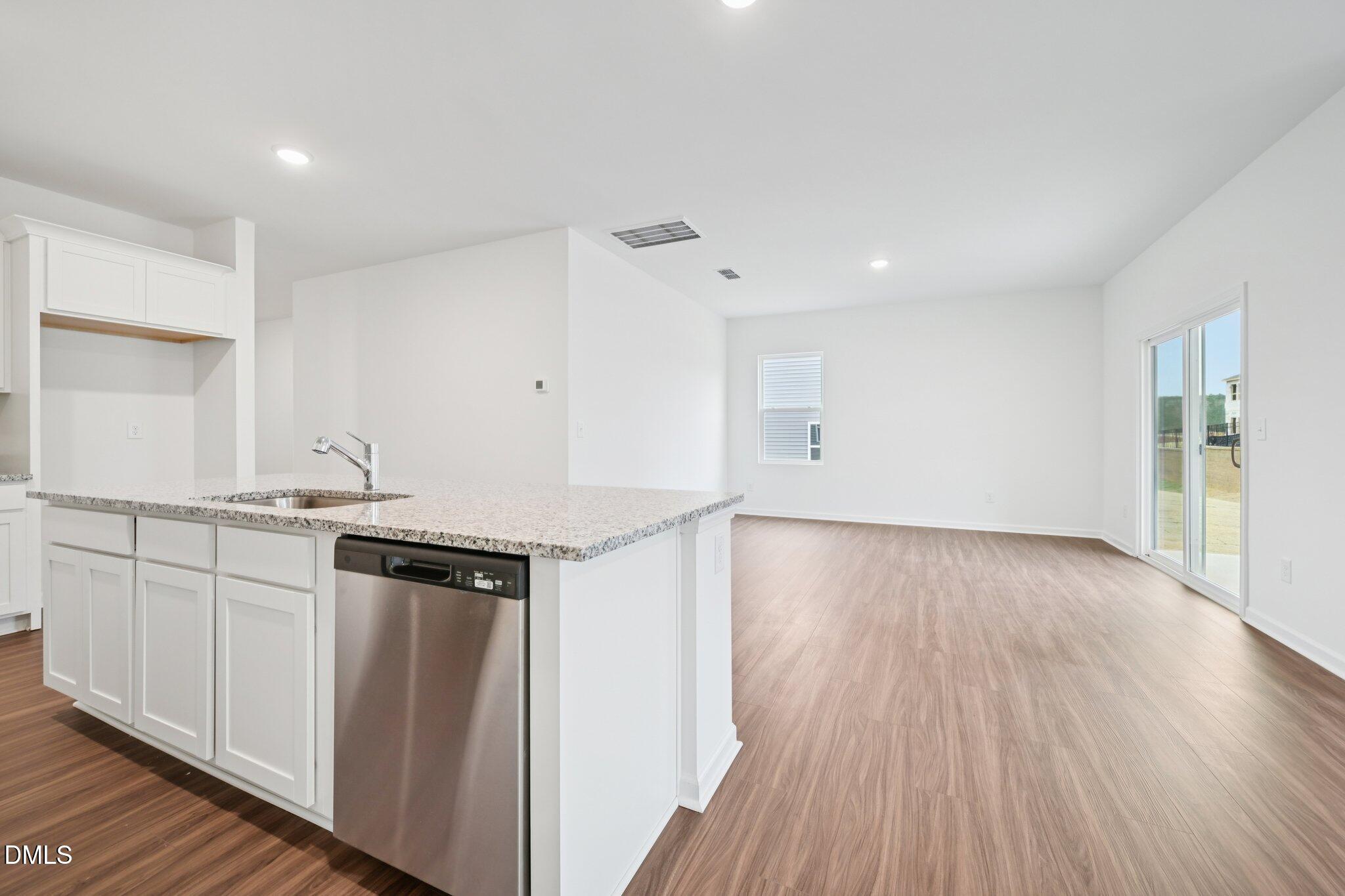 11210 Salers Loop Middlesex, NC 27557 - Photo 22 of 53 a kitchen with granite countertop a stove and a refrigerator