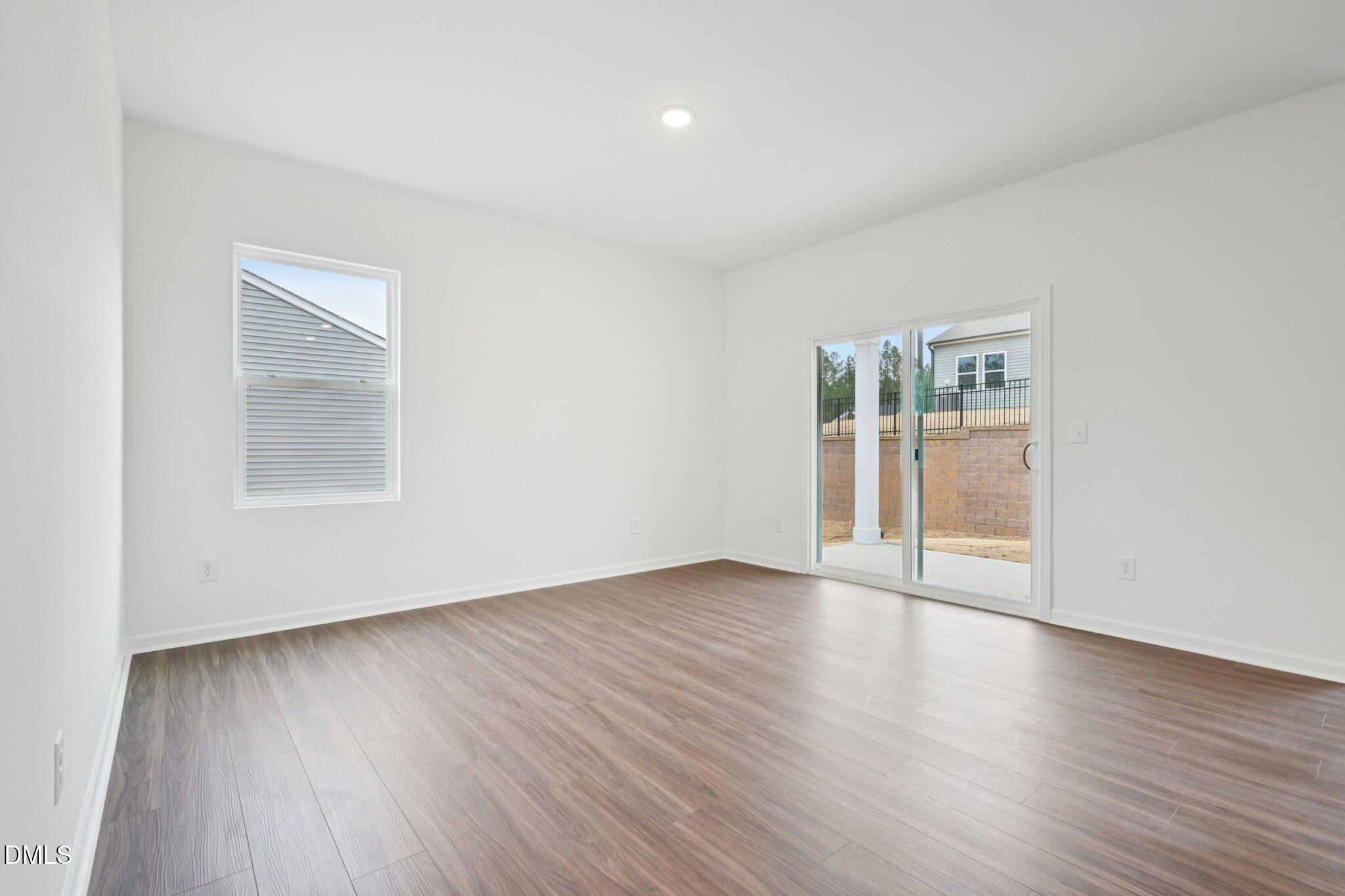 11210 Salers Loop Middlesex, NC 27557 - Photo 25 of 53 an empty room with wooden floor and a window