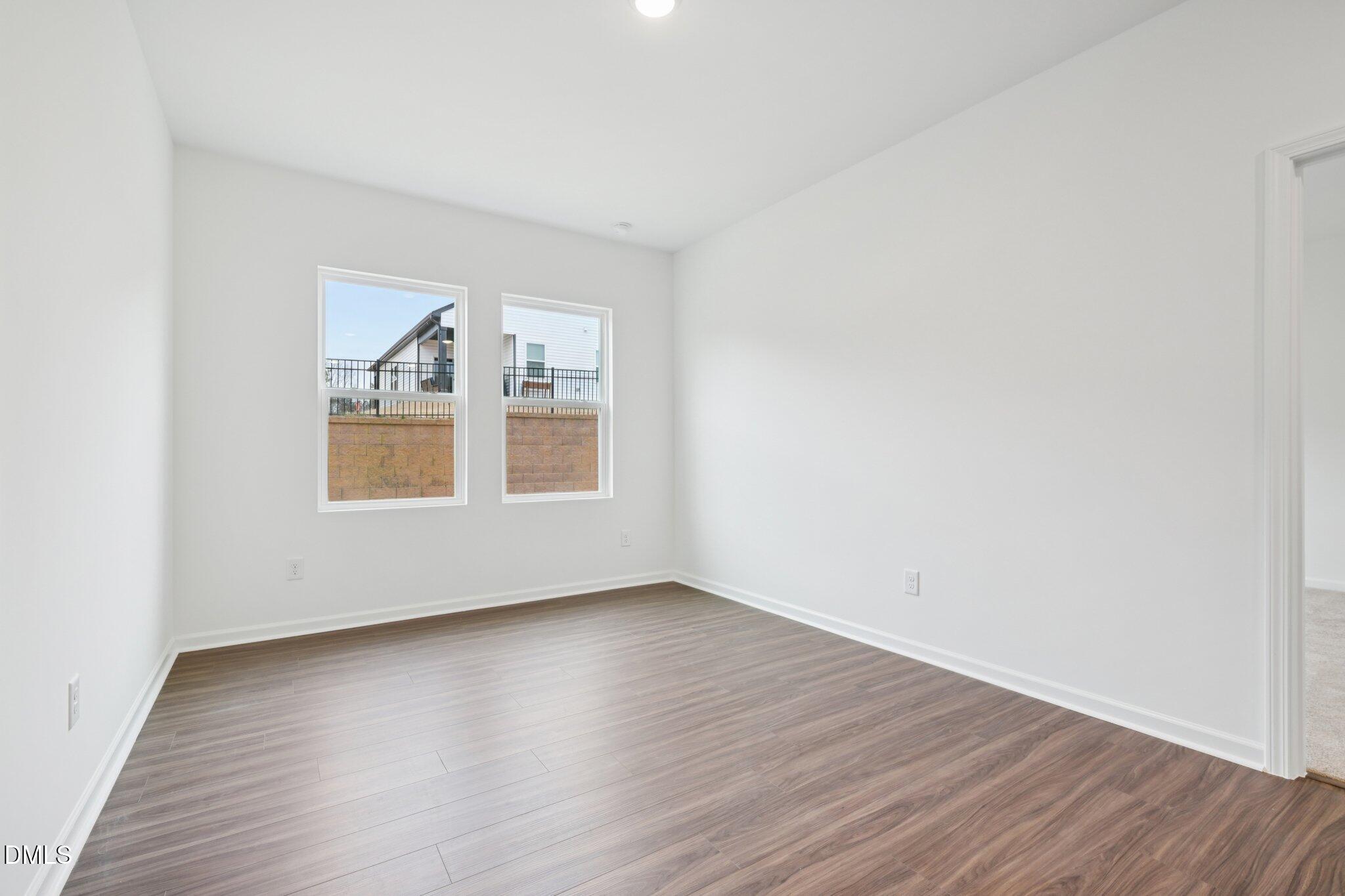 11210 Salers Loop Middlesex, NC 27557 - Photo 27 of 53 an empty room with wooden floor and windows