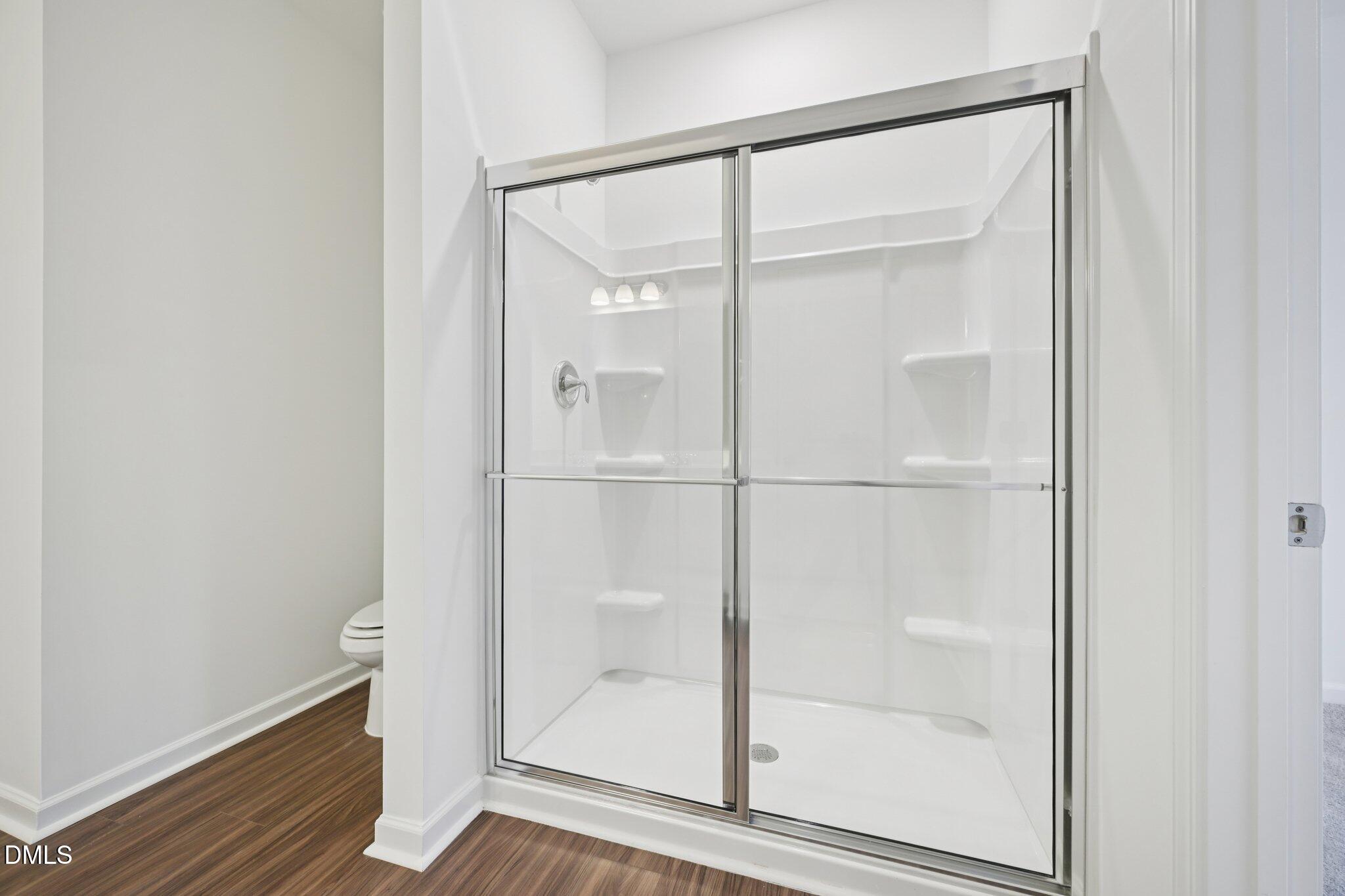 11210 Salers Loop Middlesex, NC 27557 - Photo 34 of 53 a bathroom with a glass shower door