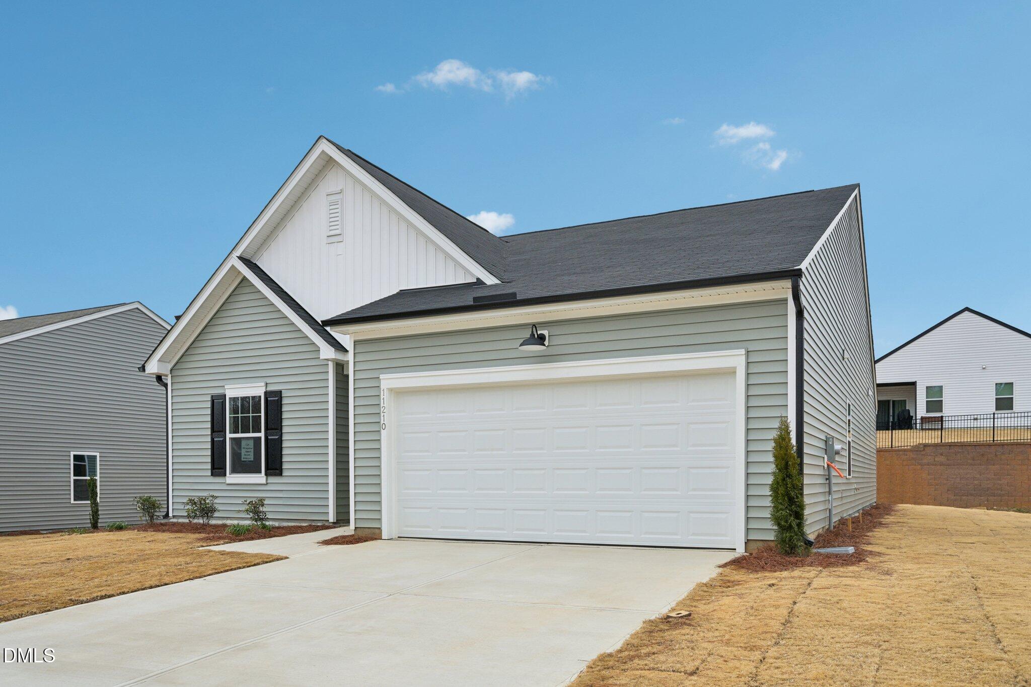 11210 Salers Loop Middlesex, NC 27557 - Photo 4 of 53 a front view of a house with a garage