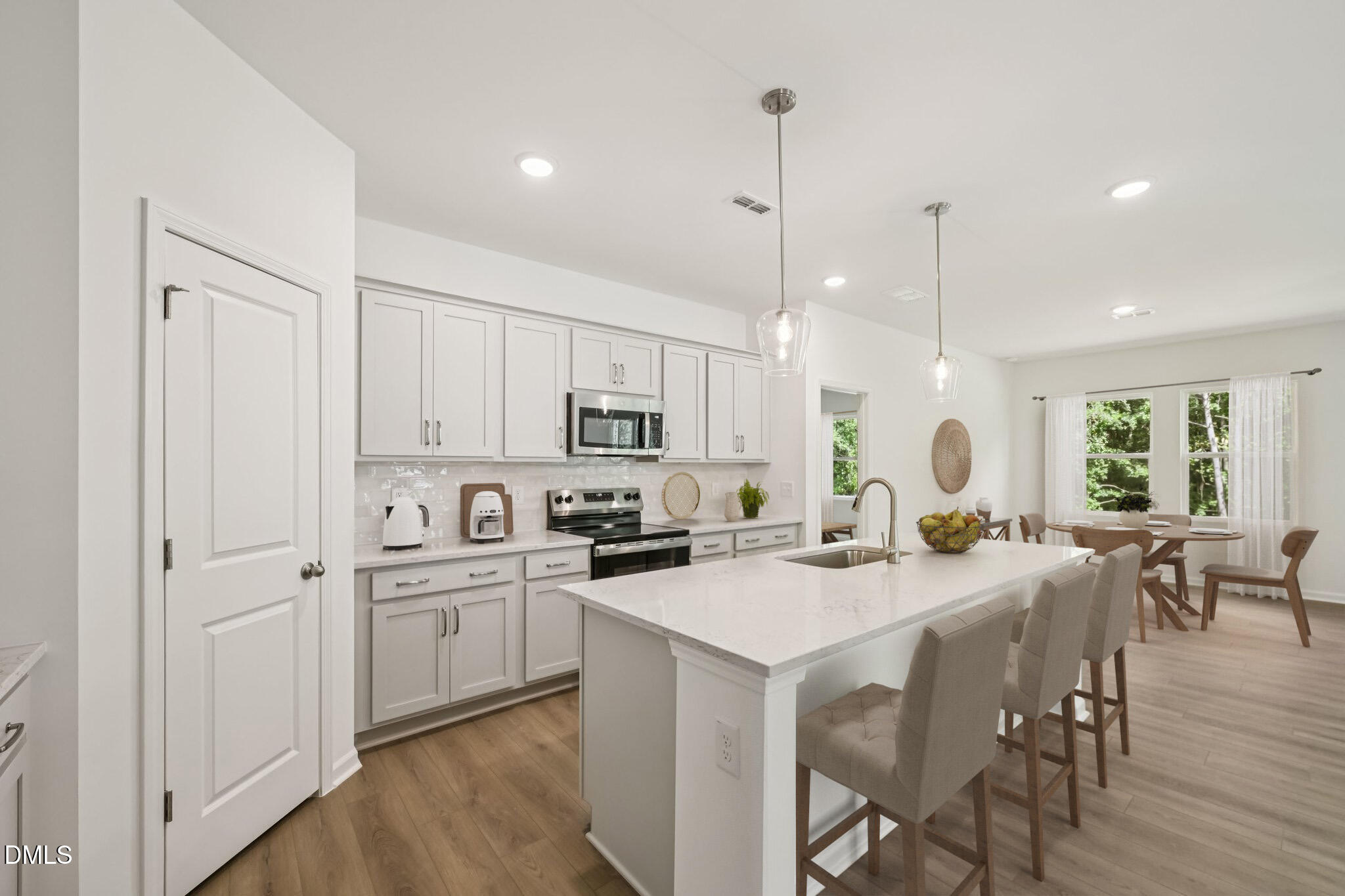 11210 Salers Loop Middlesex, NC 27557 - Photo 50 of 53 a kitchen with appliances a sink a counter top space and a center island