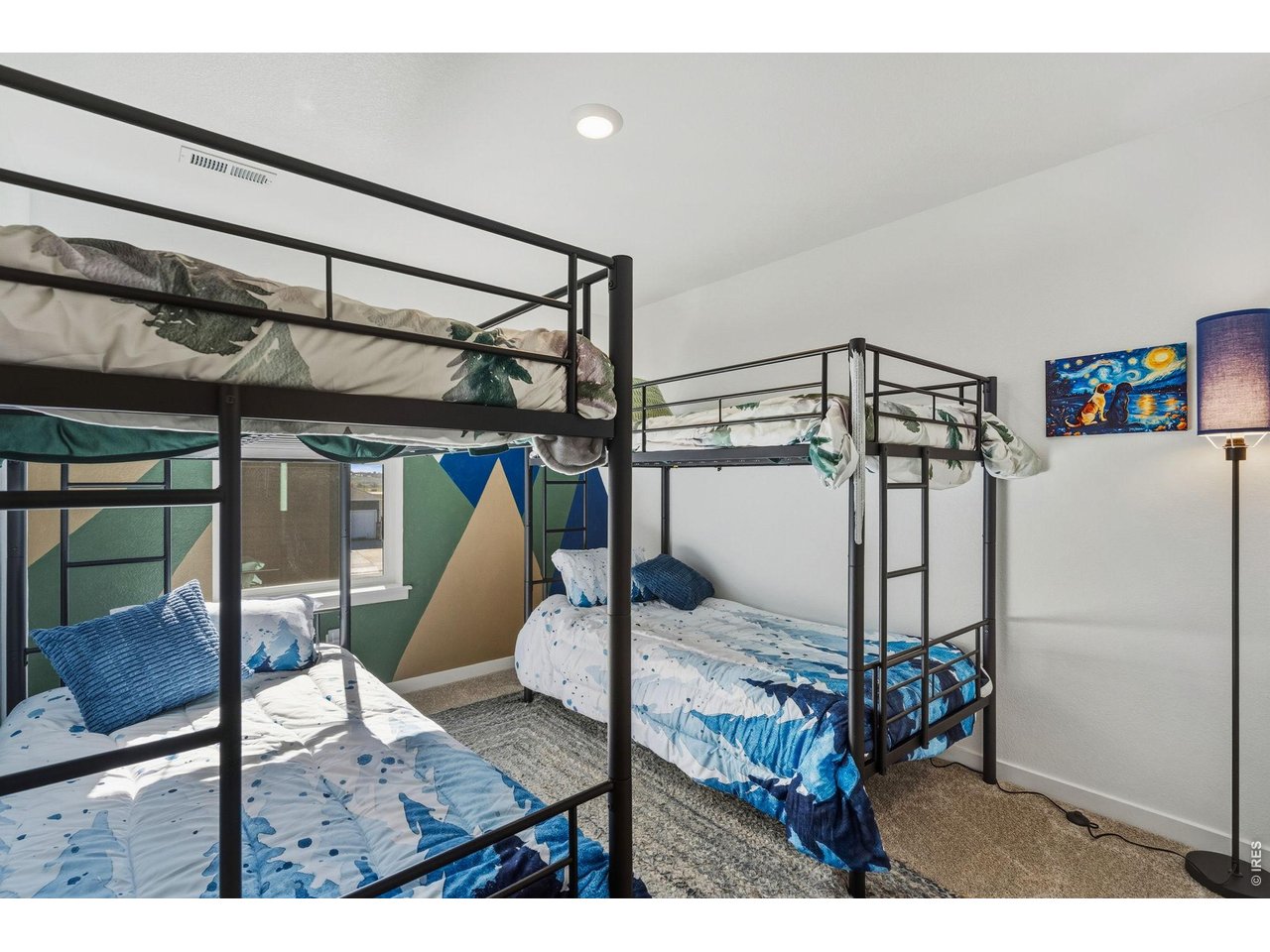 438 Bluebird Road Johnstown, CO 80534 - Photo 24 of 33 Secondary bedroom configured with bunk beds, ceiling fan, and window; flexible for guests or kids.