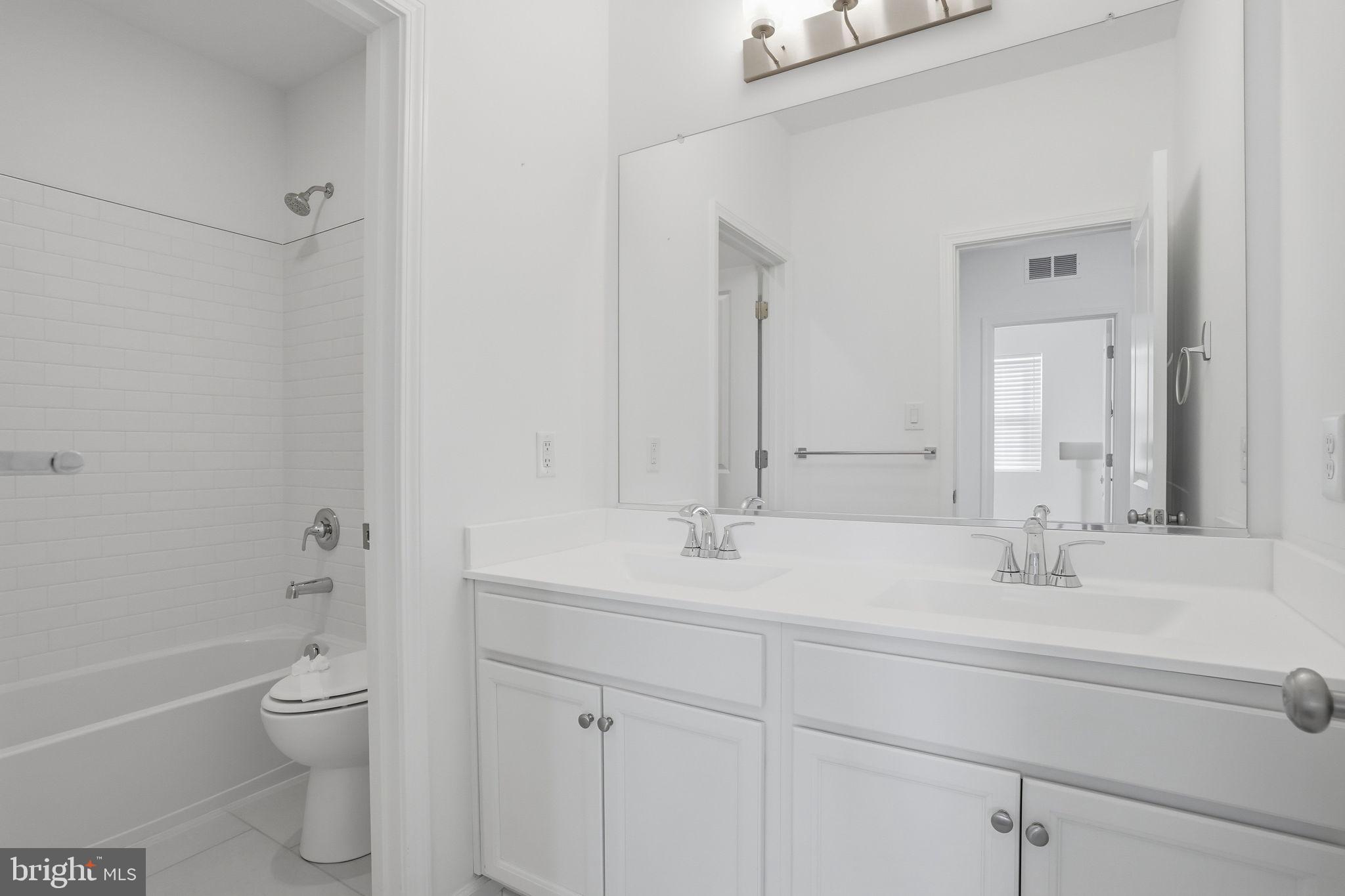 23402 Buttonbush Way Millville, DE 19967 - Photo 13 of 52 a bathroom with a sink a toilet and shower