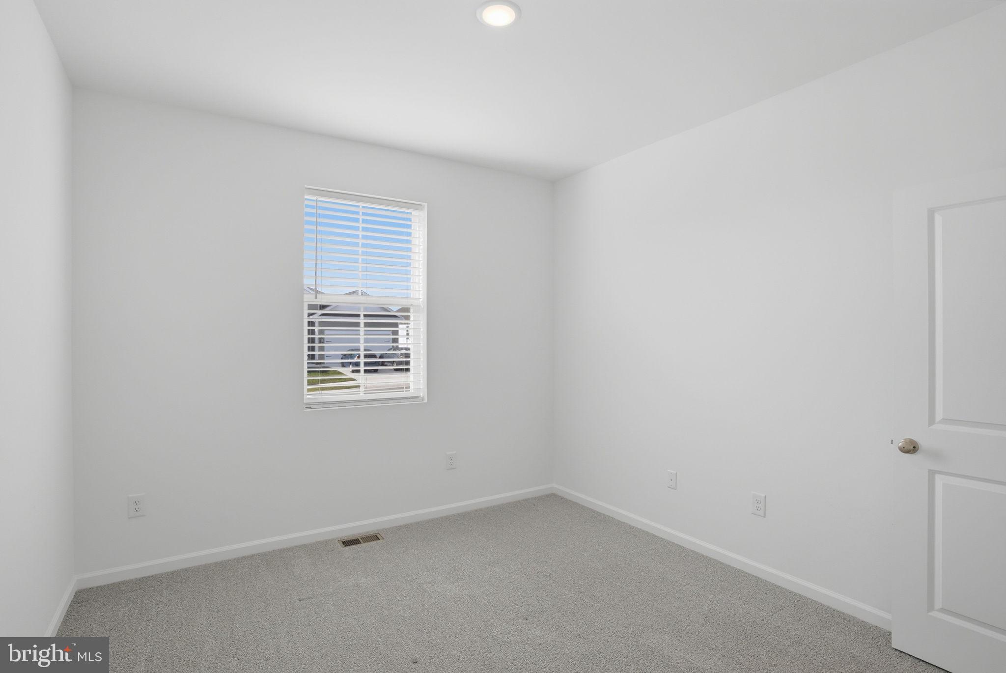 23402 Buttonbush Way Millville, DE 19967 - Photo 15 of 52 an empty room with a window