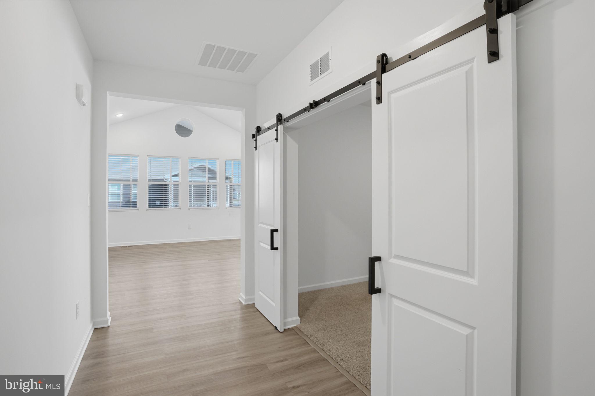 23402 Buttonbush Way Millville, DE 19967 - Photo 18 of 52 a view of a big room with wooden floor and windows