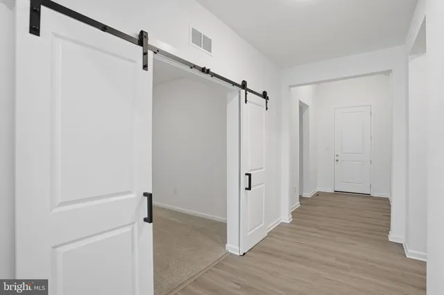 a view of a room with wooden floor