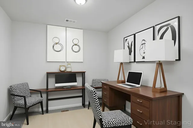 a view of a workspace with furniture