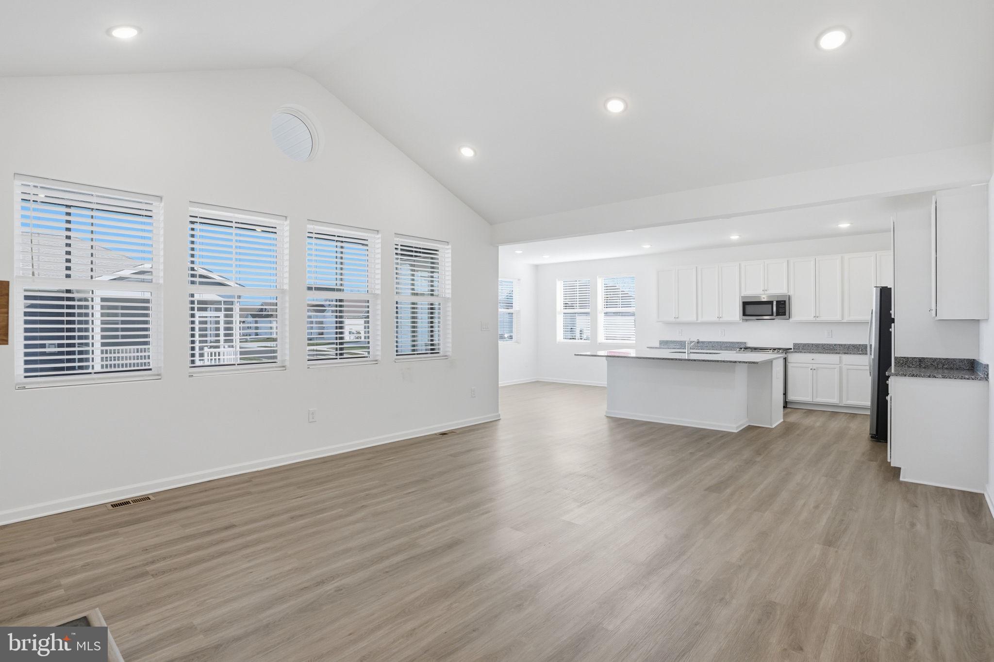 23402 Buttonbush Way Millville, DE 19967 - Photo 25 of 52 a view of kitchen with wooden floor and windows