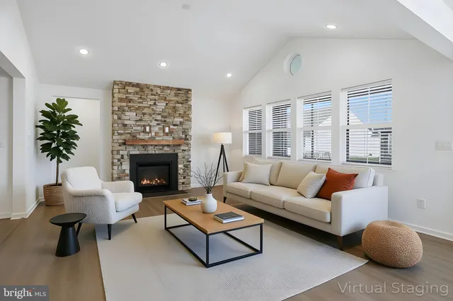 an empty room with windows and fireplace