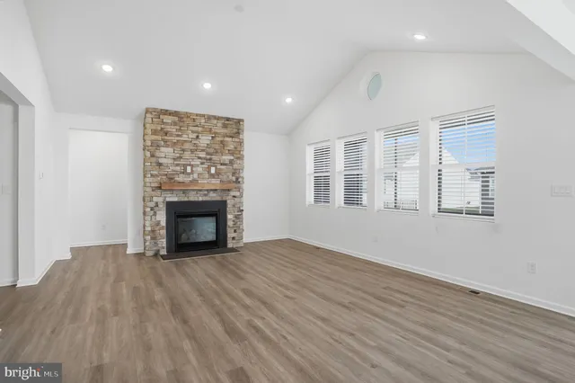 a kitchen with stainless steel appliances granite countertop a sink and cabinets with wooden floors