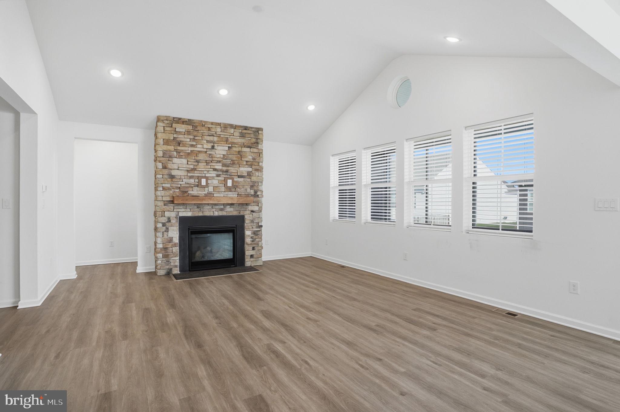 23402 Buttonbush Way Millville, DE 19967 - Photo 29 of 52 an empty room with windows and fireplace