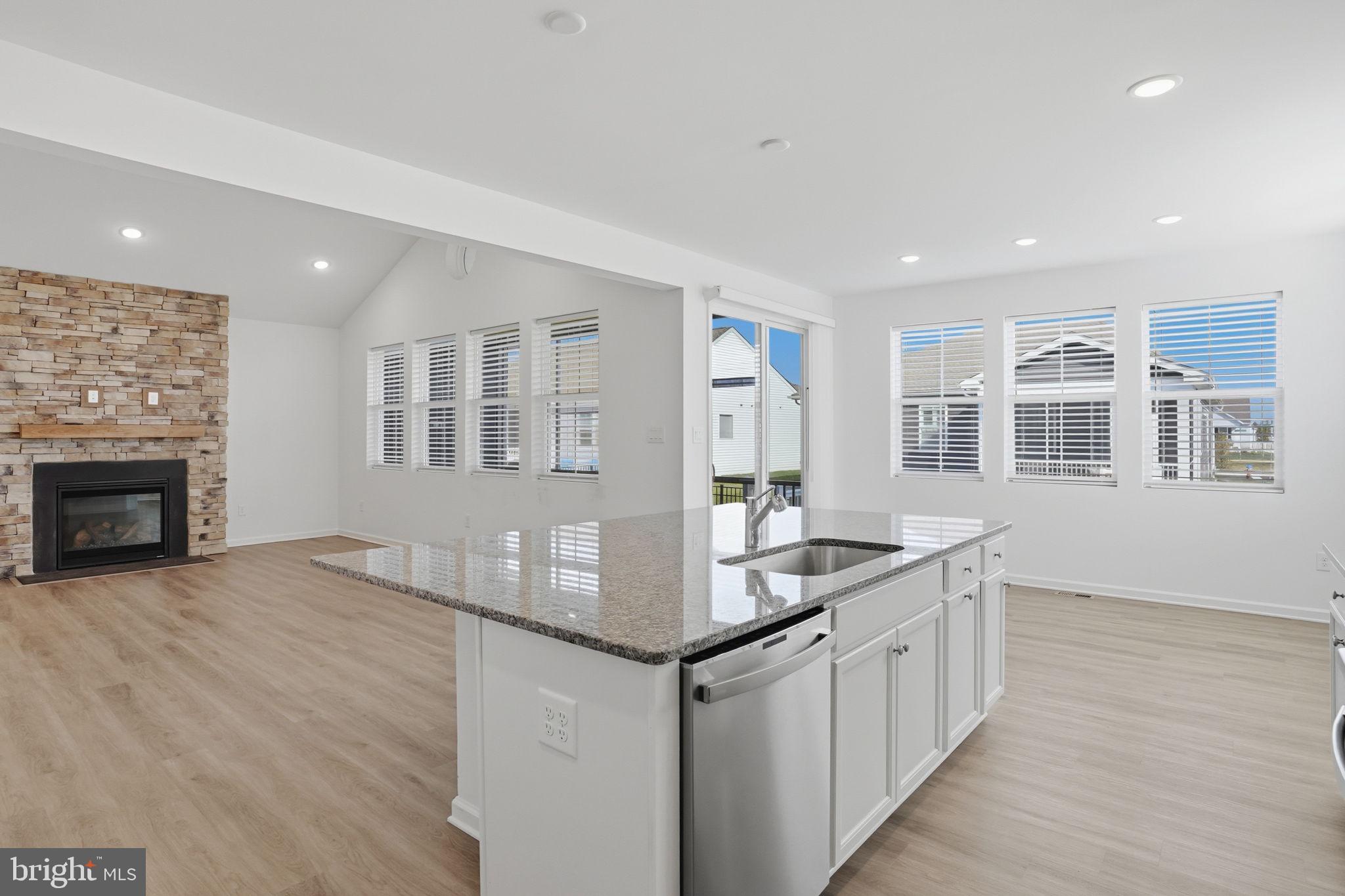 23402 Buttonbush Way Millville, DE 19967 - Photo 35 of 52 a kitchen with stainless steel appliances granite countertop a stove cabinets and wooden floor