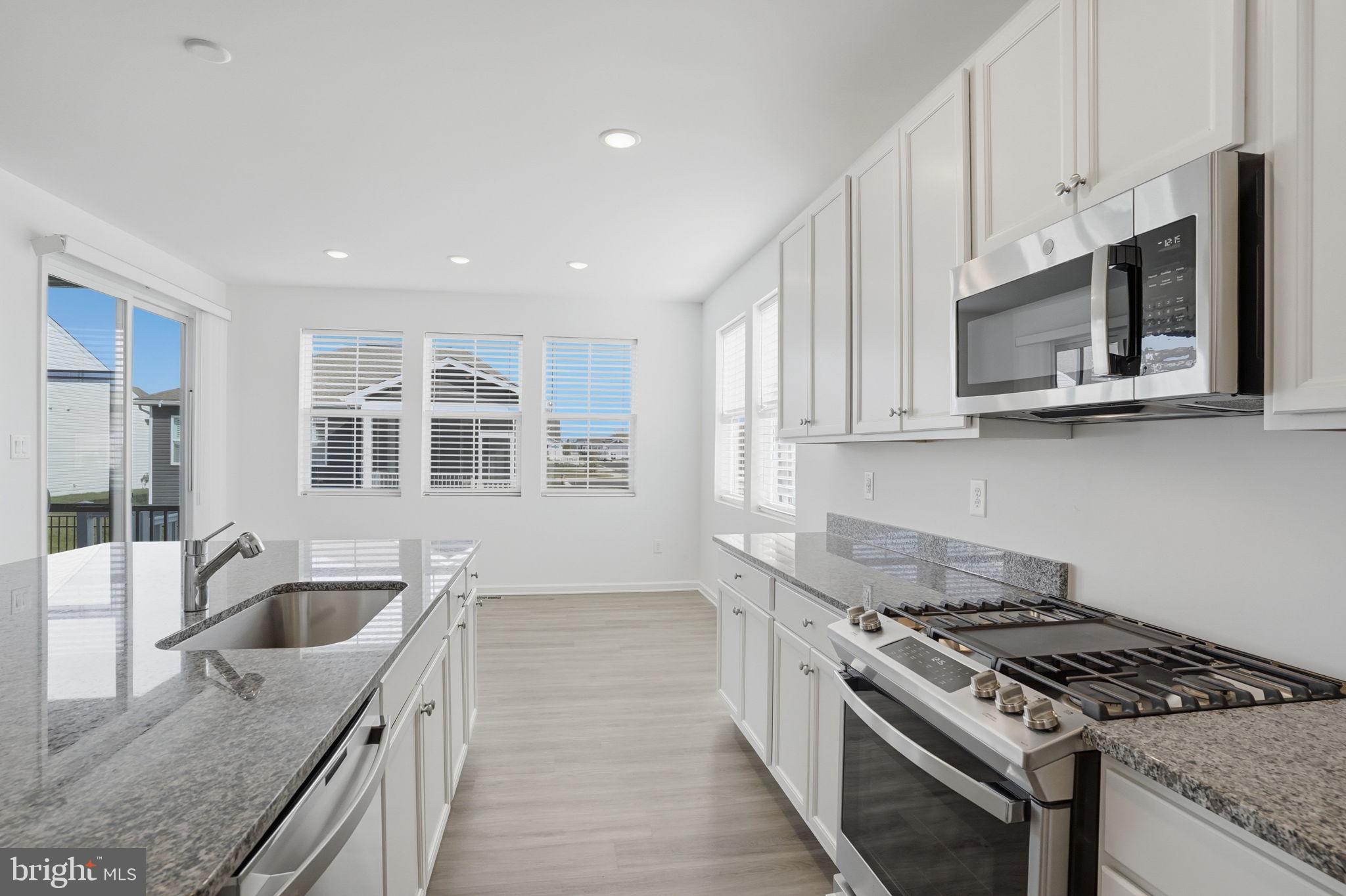 23402 Buttonbush Way Millville, DE 19967 - Photo 36 of 52 a kitchen with stainless steel appliances granite countertop white cabinets a granite counter tops and a stove