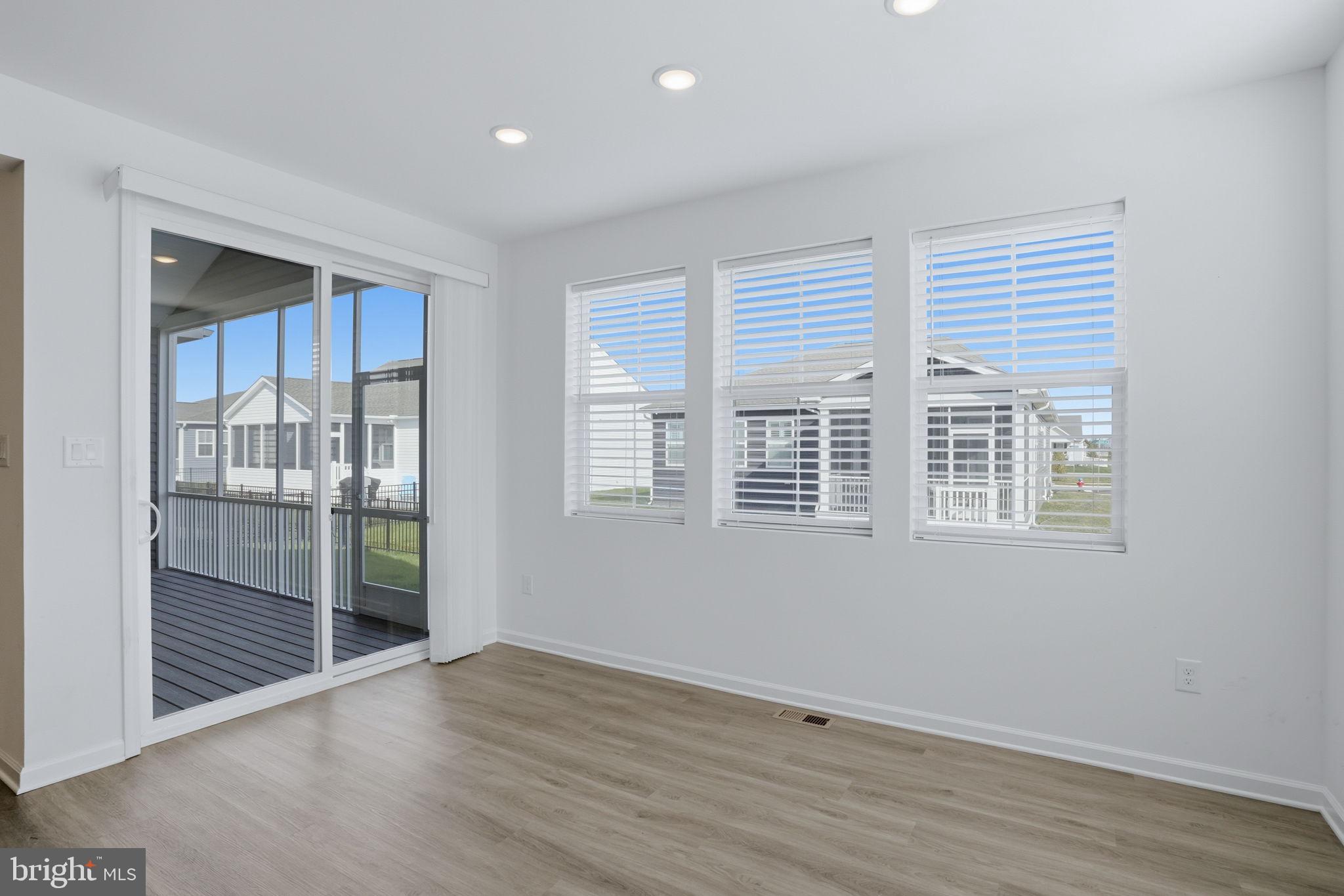 23402 Buttonbush Way Millville, DE 19967 - Photo 37 of 52 a view of an empty room with wooden floor and a window