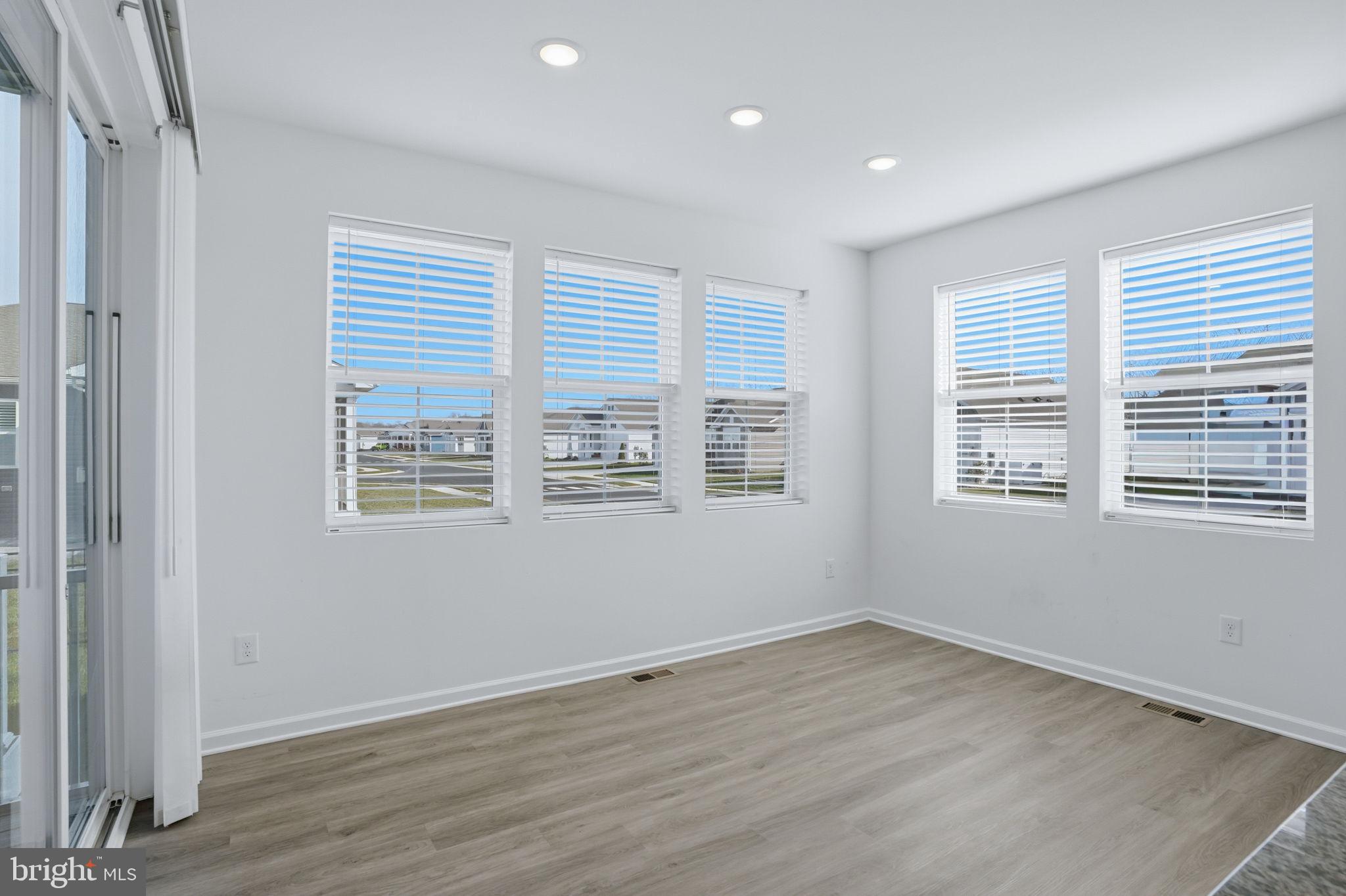 23402 Buttonbush Way Millville, DE 19967 - Photo 38 of 52 a view of an empty room with wooden floor and a window