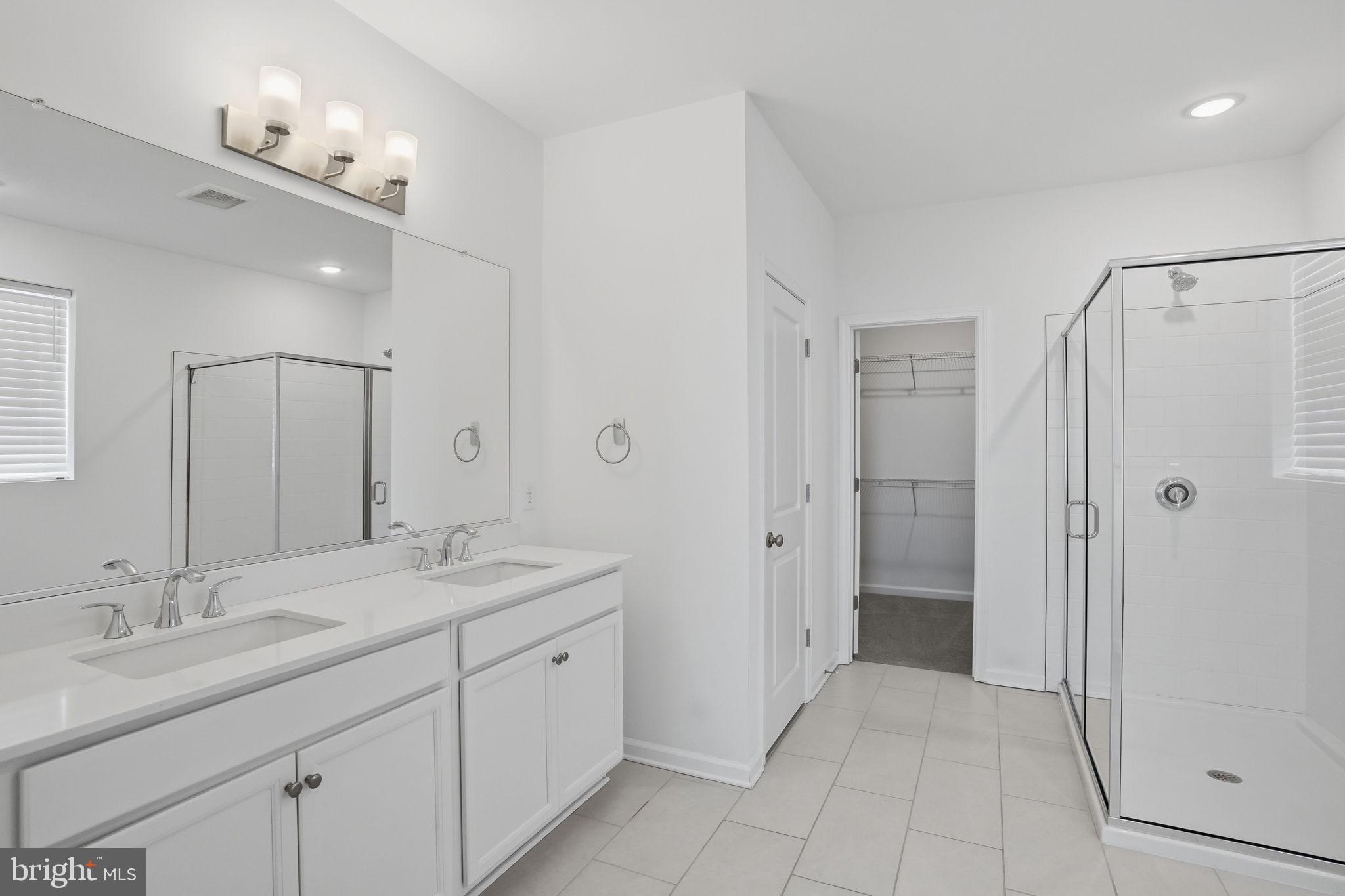 23402 Buttonbush Way Millville, DE 19967 - Photo 43 of 52 a spacious bathroom with a granite countertop sink a mirror and a shower