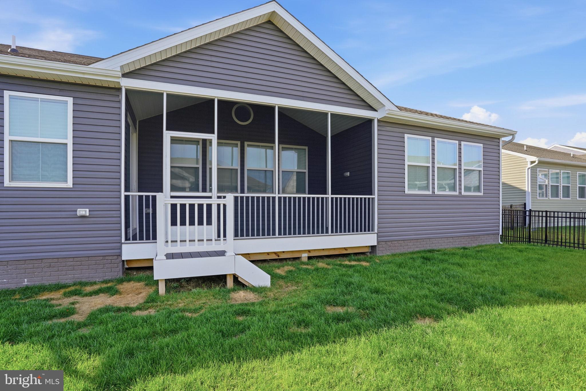23402 Buttonbush Way Millville, DE 19967 - Photo 47 of 52 a view of a house with a backyard