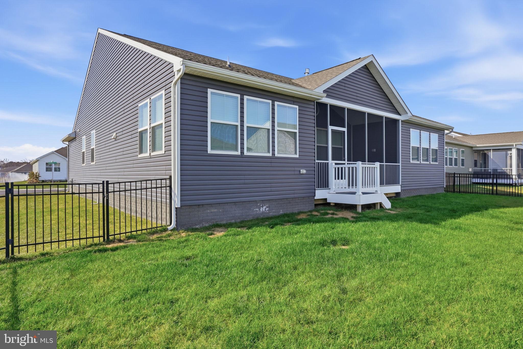 23402 Buttonbush Way Millville, DE 19967 - Photo 48 of 52 a front view of a house with a garden