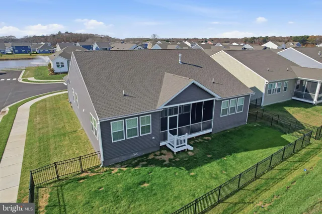 an aerial view of a house with a big yard and large trees