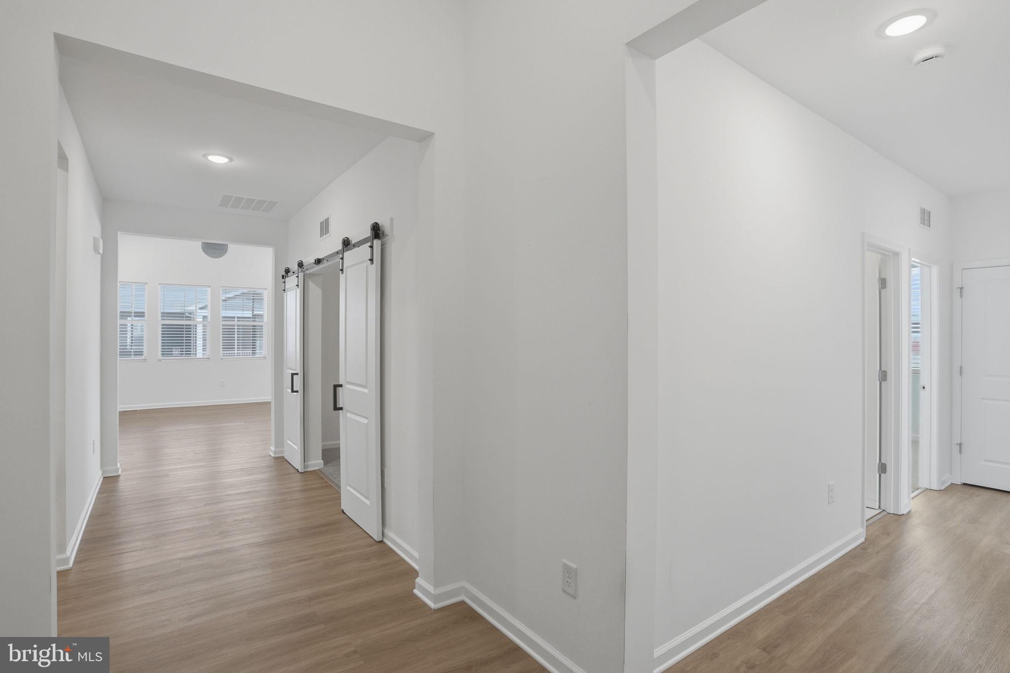23402 Buttonbush Way Millville, DE 19967 - Photo 10 of 52 a view of a hallway with wooden floor
