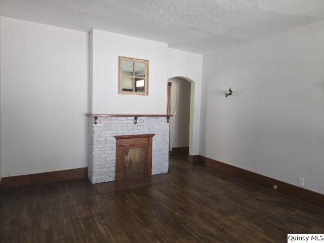 210 Main Street Carthage, IL 62321 - Photo 9 of 36 a view of empty room with wooden floor and fireplace