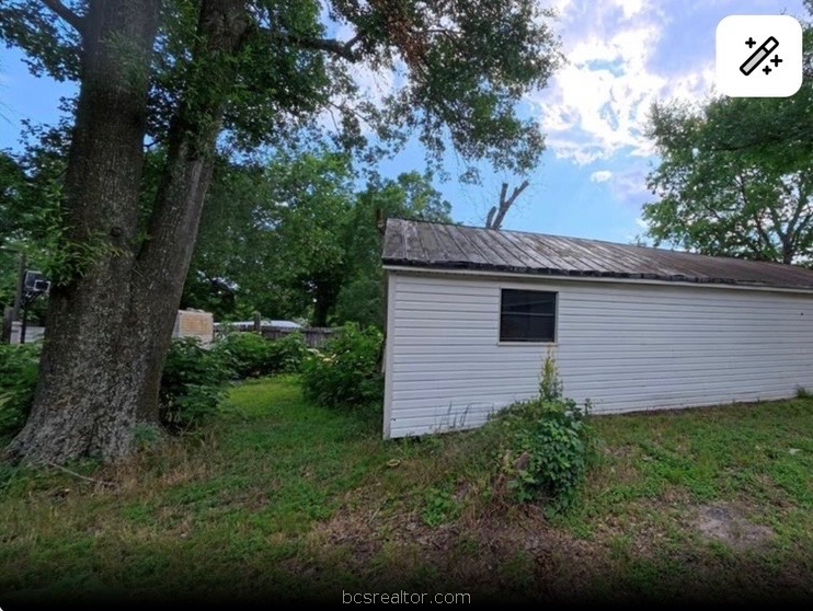 1203 Boulevard Street Bryan, TX 77803 - Photo 5 of 16 a view of a backyard with plants and large tree