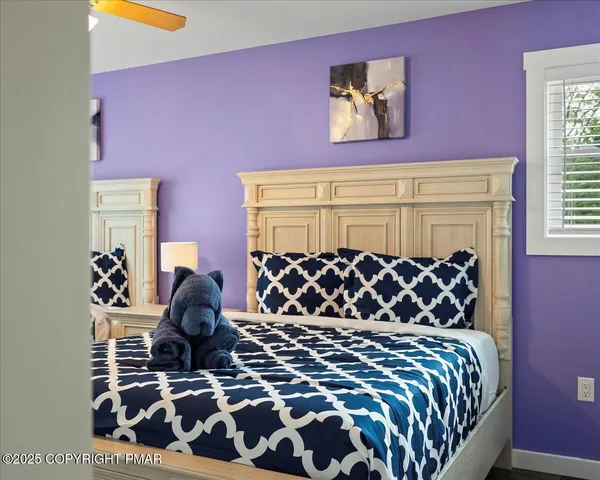 a bedroom with two beds and a window