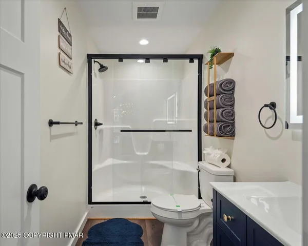 a bedroom with bed and a flat tv screen