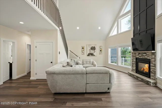 a living room with furniture and a projector screen