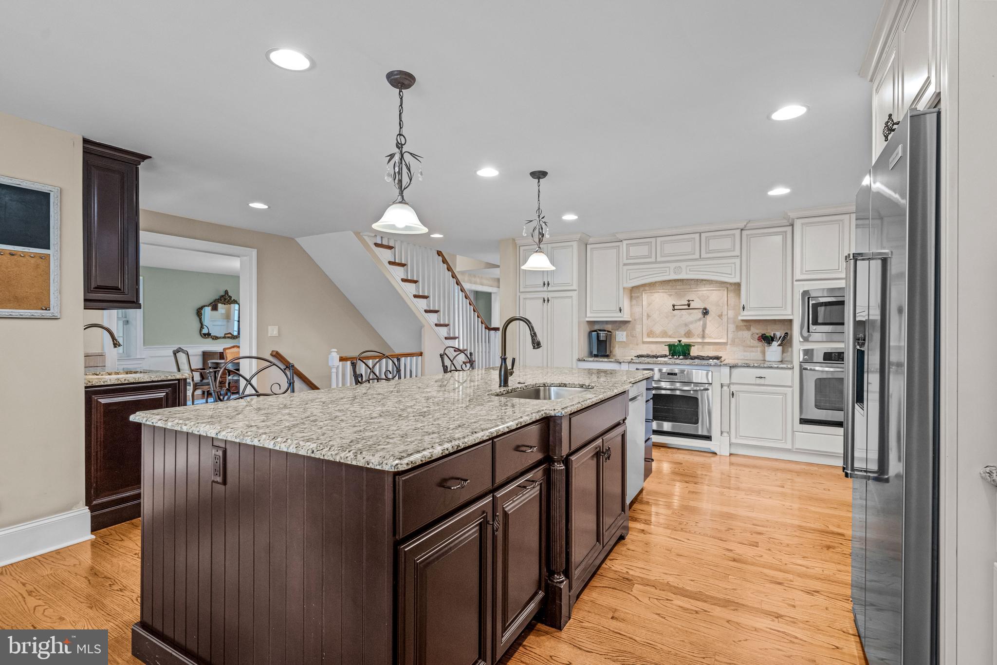 113 Deepdale Road Wayne, PA 19087 - Photo 13 of 68 a kitchen with stainless steel appliances granite countertop a sink a stove and a refrigerator