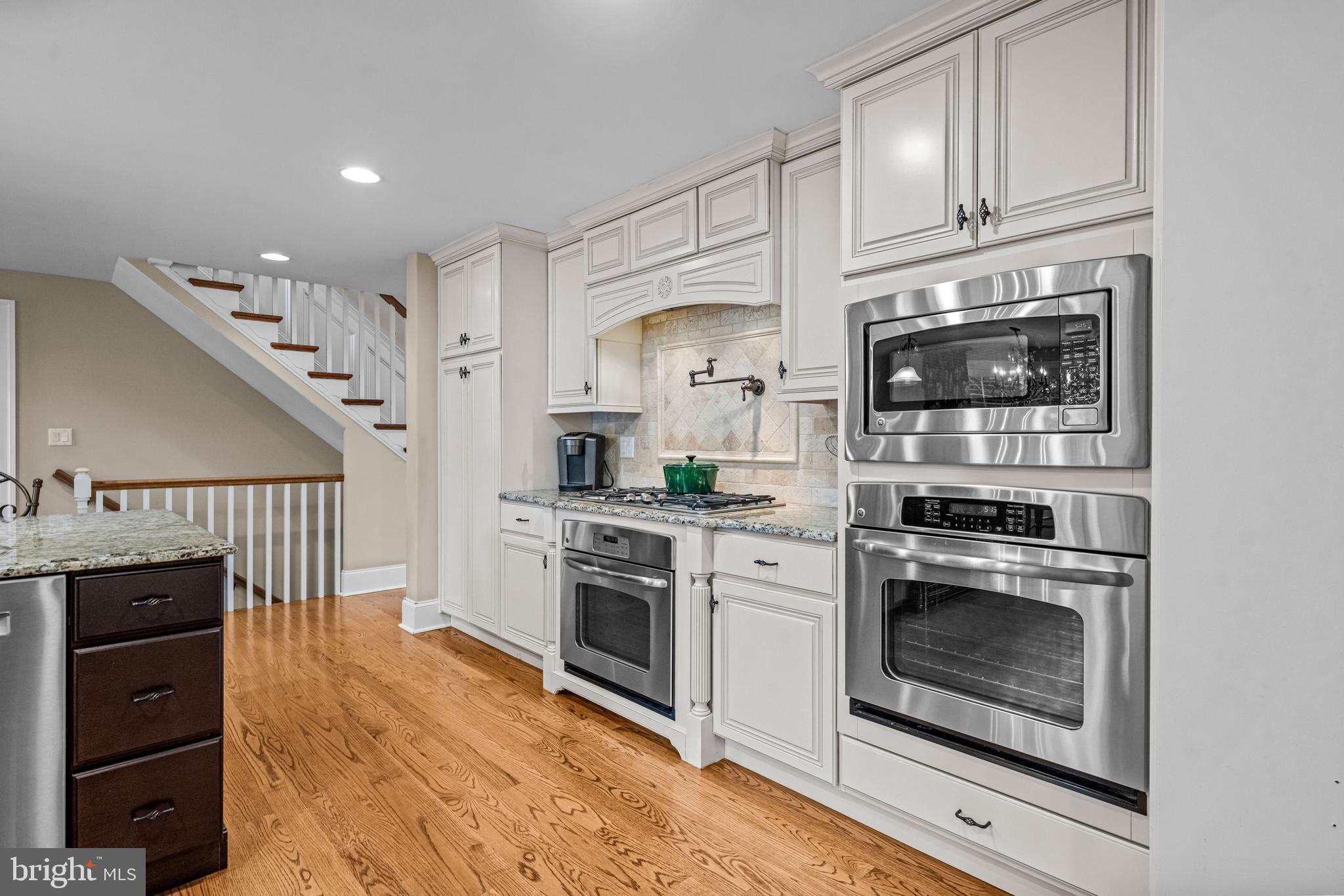 113 Deepdale Road Wayne, PA 19087 - Photo 14 of 68 a kitchen with granite countertop a stove and a refrigerator