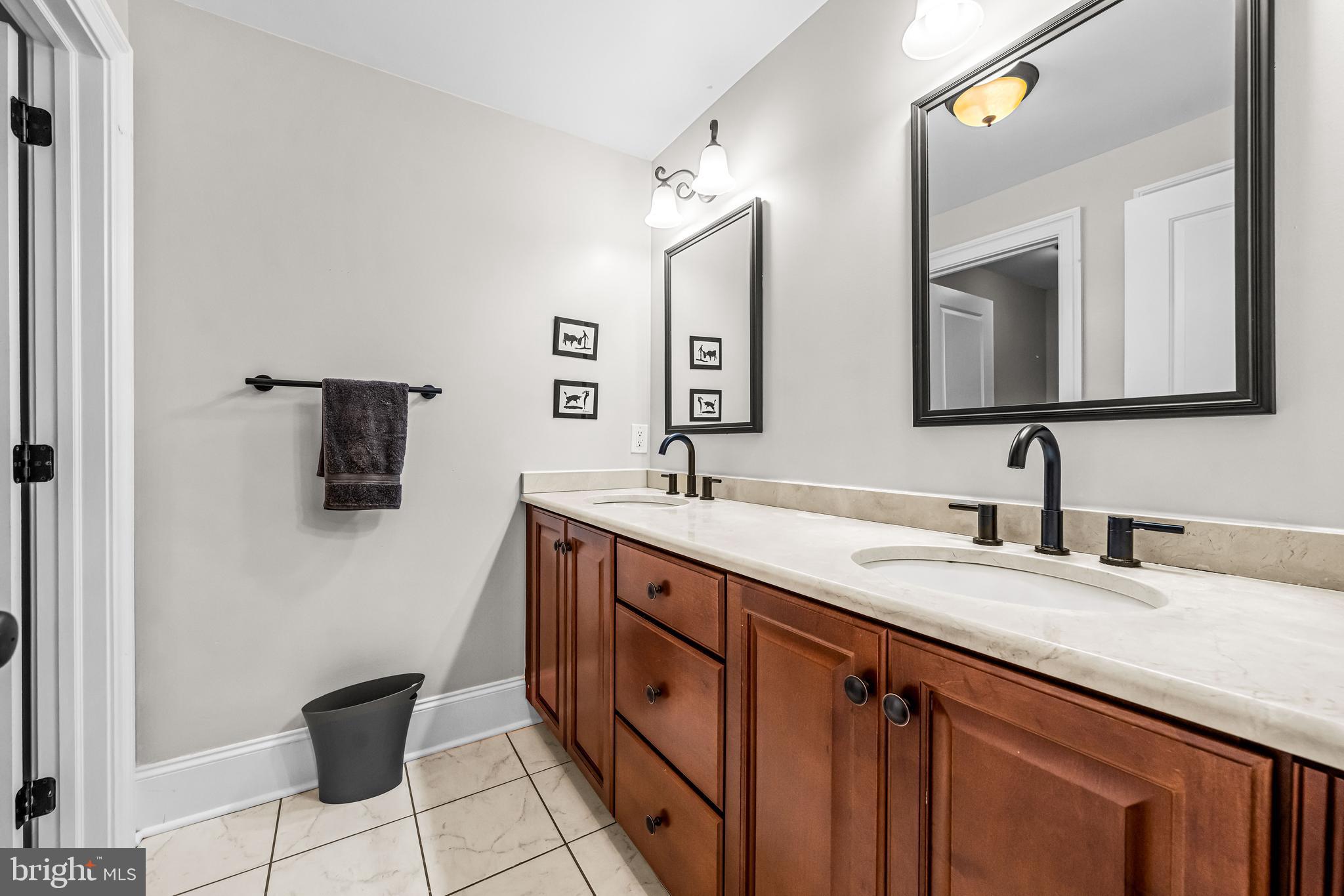 113 Deepdale Road Wayne, PA 19087 - Photo 39 of 68 a spacious bathroom with a double vanity sink and a mirror