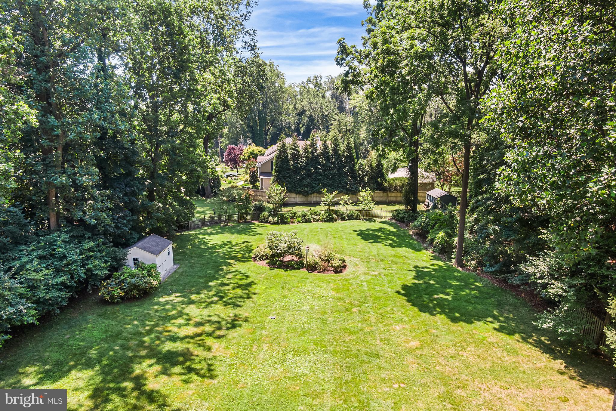 113 Deepdale Road Wayne, PA 19087 - Photo 60 of 68 a backyard of a house with lots of green space and plants