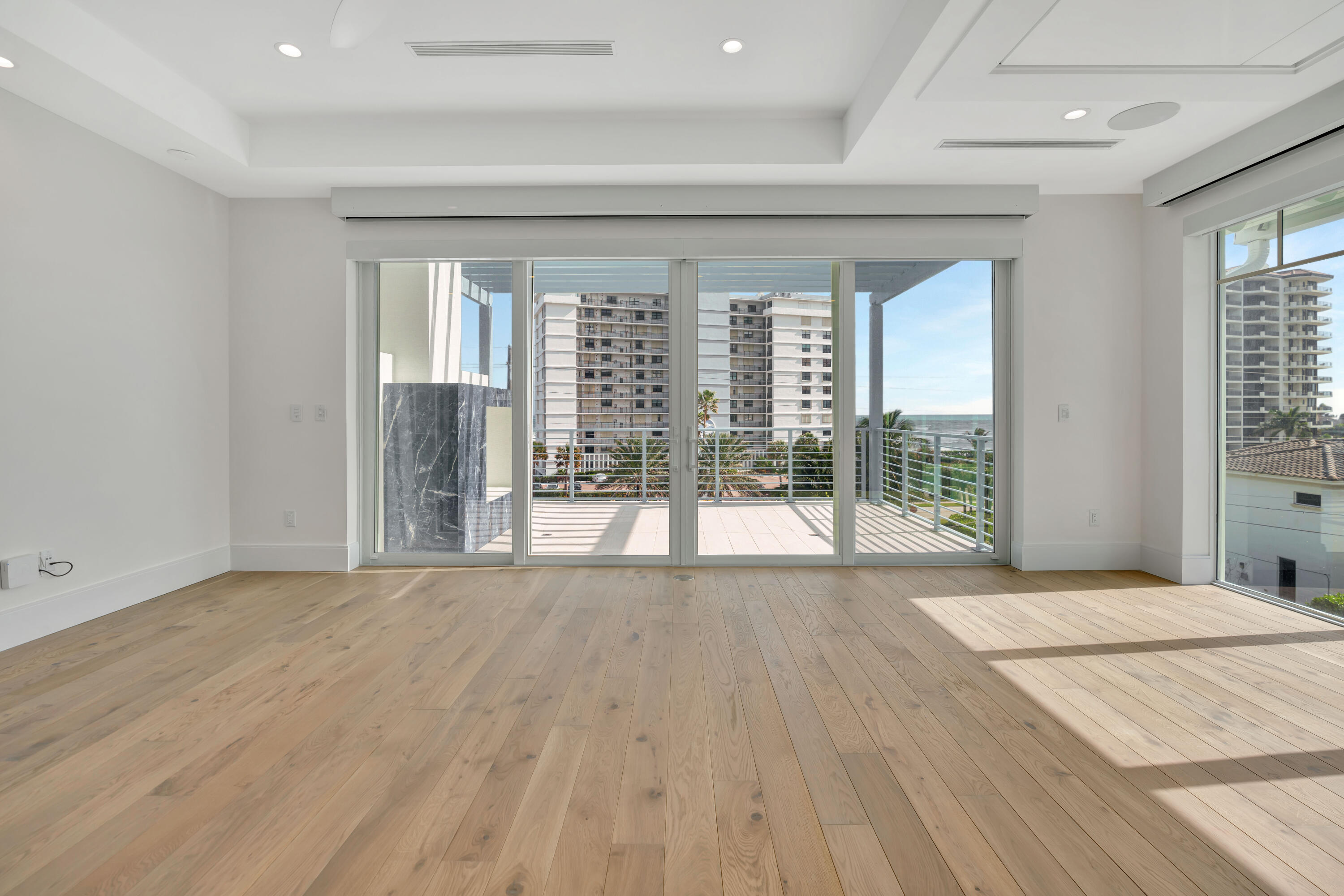 461 Venus Drive, Unit B Juno Beach, FL 33408 - Photo 41 of 85 a view of an empty room with wooden floor and a window