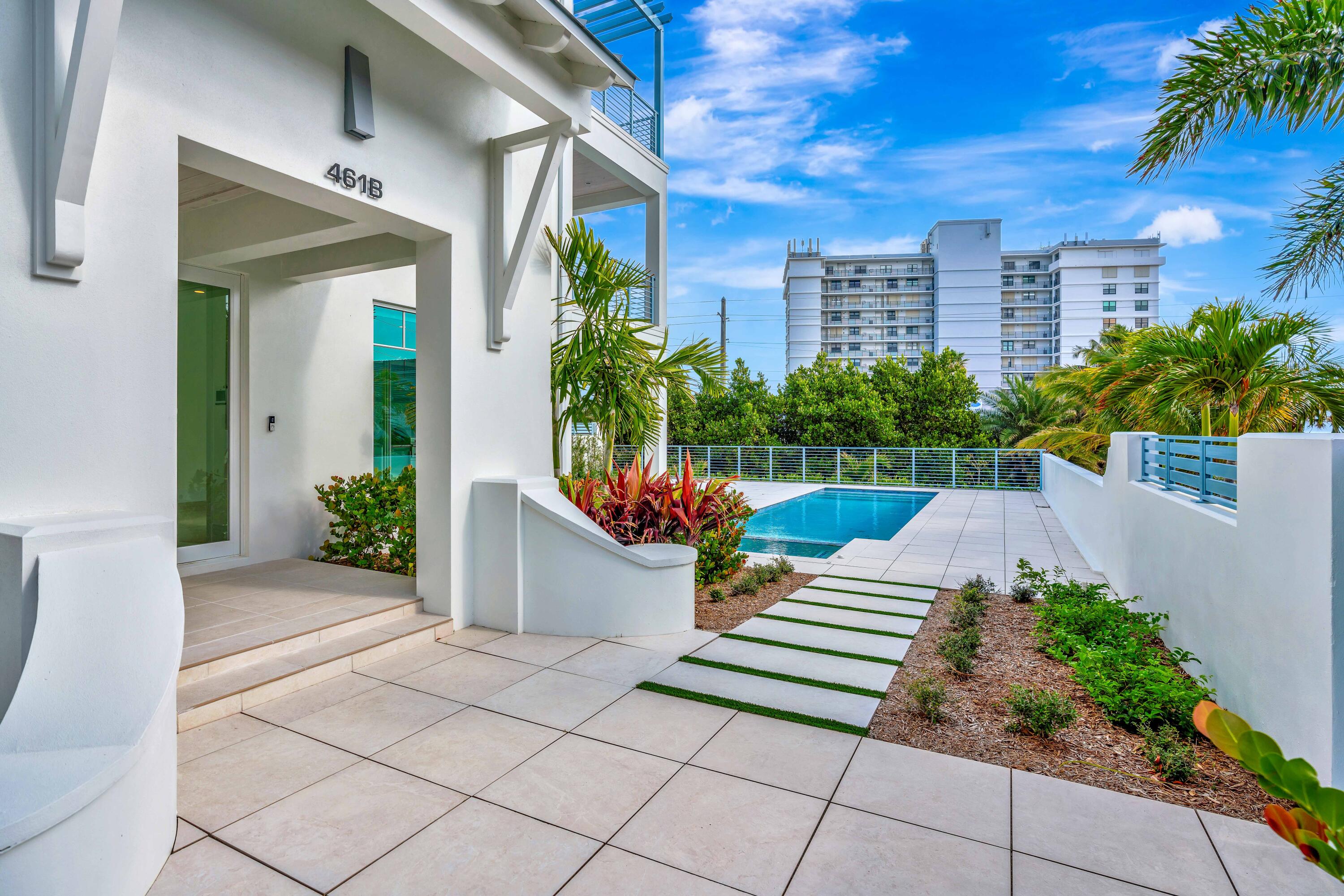 461 Venus Drive, Unit B Juno Beach, FL 33408 - Photo 5 of 85 a view of a house with a yard and potted plants