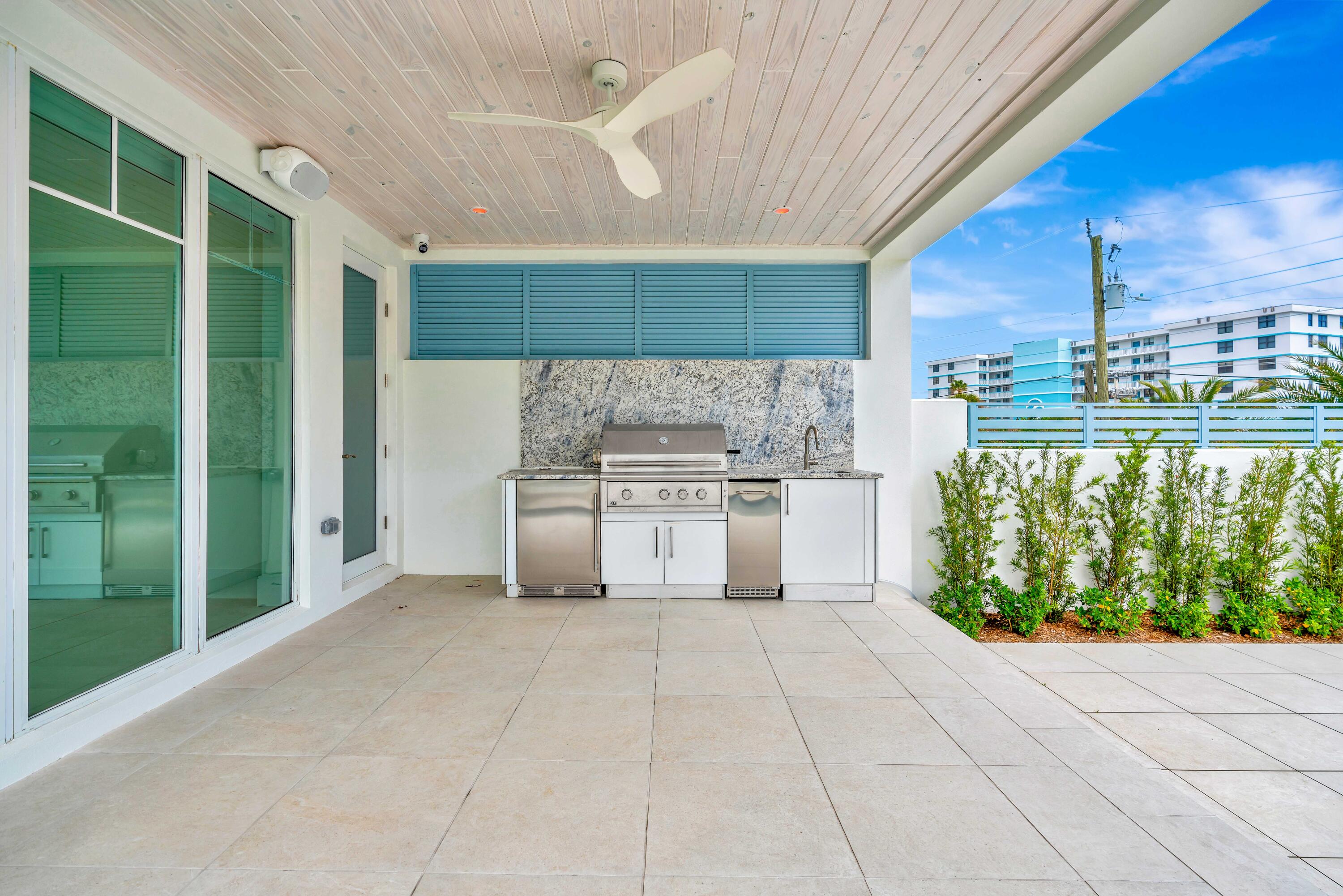 461 Venus Drive, Unit B Juno Beach, FL 33408 - Photo 76 of 85 a kitchen with stainless steel appliances kitchen island granite countertop a refrigerator oven a s sink and dishwasher