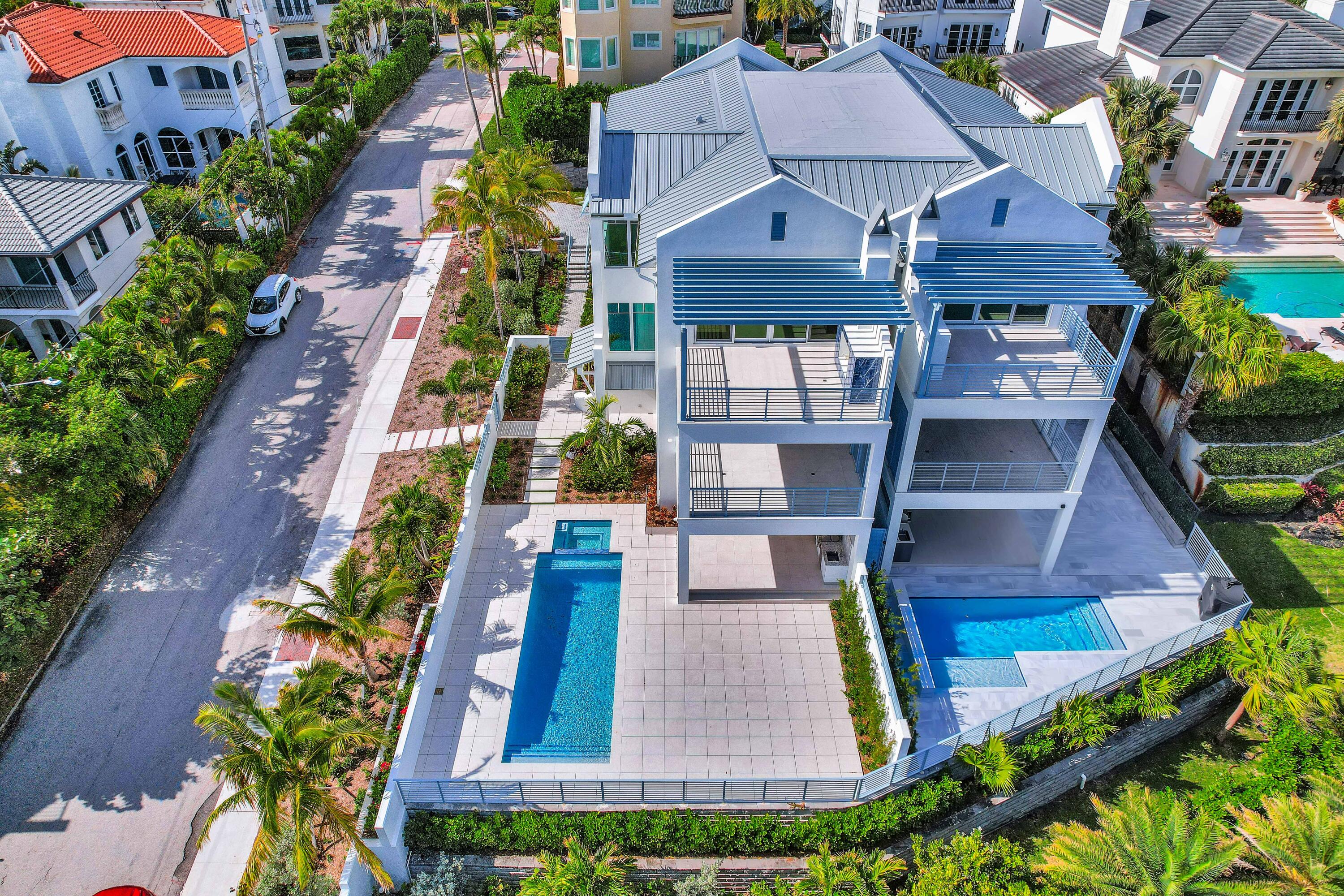461 Venus Drive, Unit B Juno Beach, FL 33408 - Photo 82 of 85 an aerial view of multiple houses with a yard