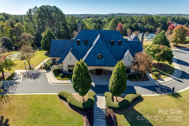 an aerial view of a house patio swimming pool and outdoor seating