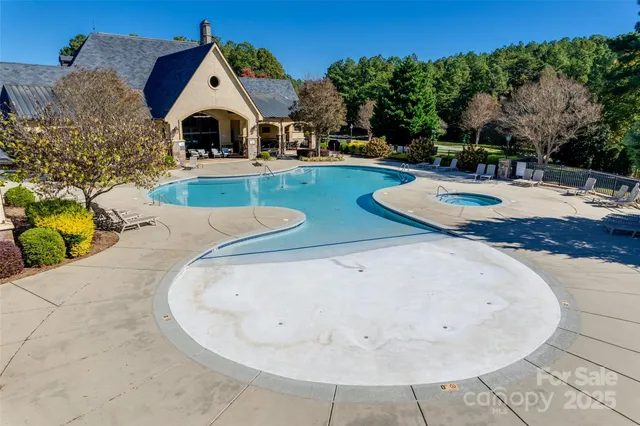 a backyard of a house with table and chairs a barbeque with wooden fence