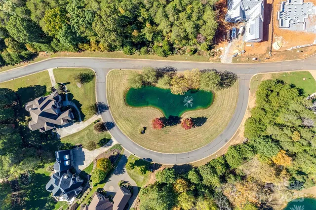 an aerial view of a house with a yard and garden
