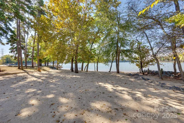 an aerial view of a house with swimming pool and patio